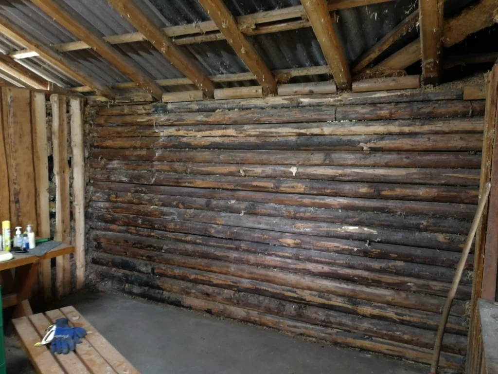 Dunkle Wand aus Holzbalken der Schutzhütte